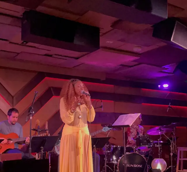 Kandace Lindsey performing with the band in a club